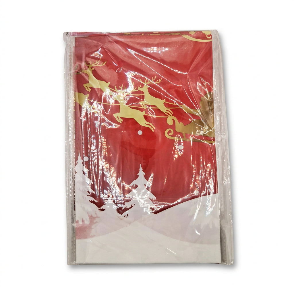 Red Christmas table cover with gold reindeer, sleigh and snowy trees
